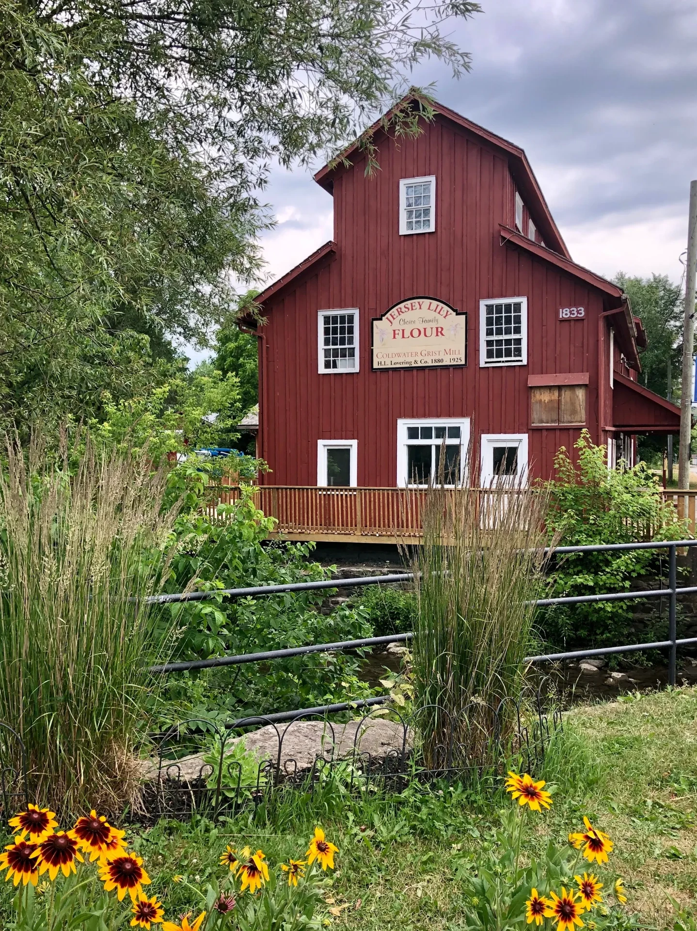 The historic Coldwater Grist Mill, a red barn-board mill built in 1833 beside the Coldwater River